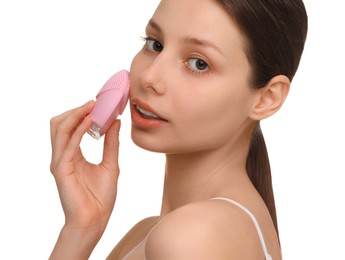 Photo of Washing face. Young woman with cleansing brush on white background