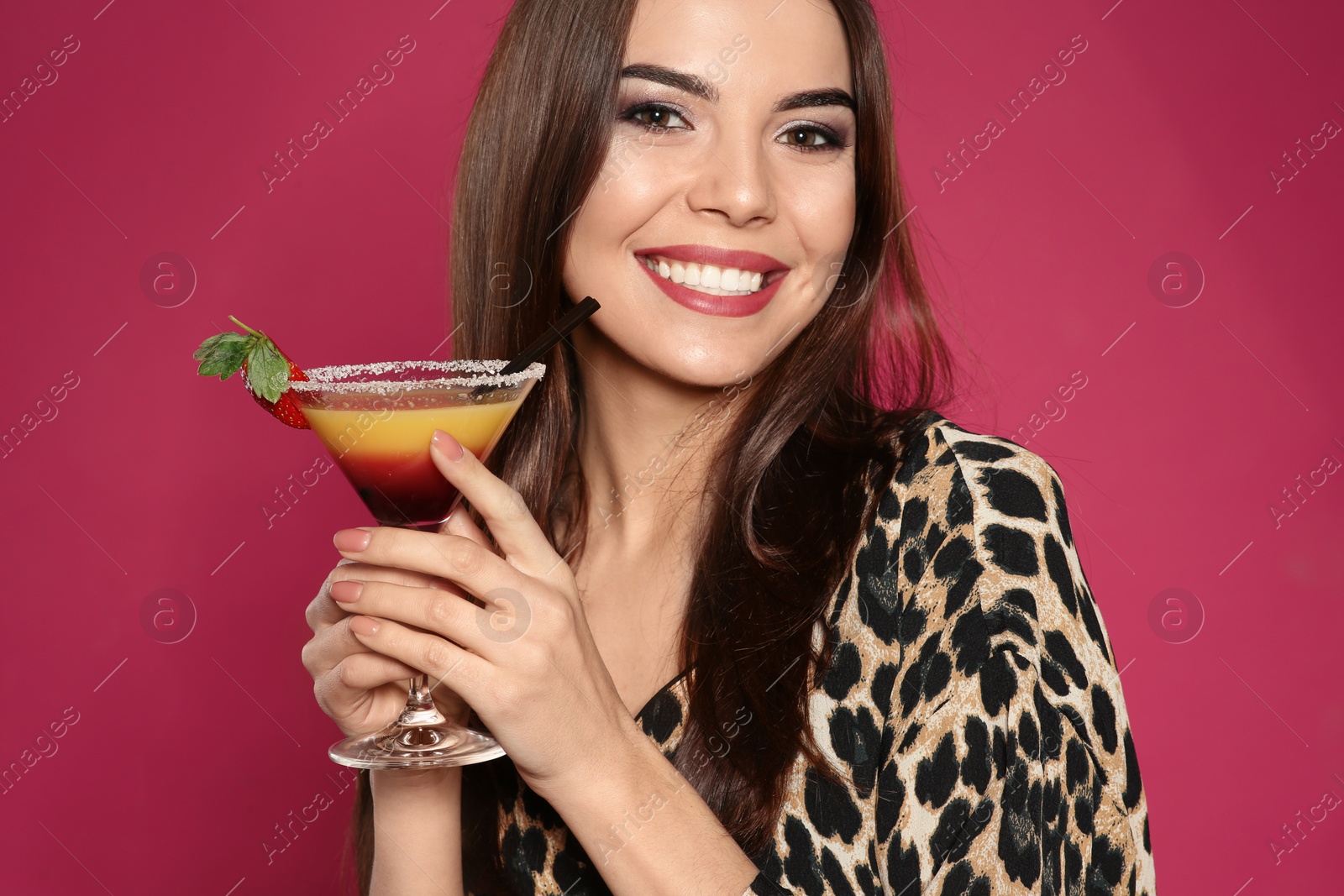 Photo of Beautiful young woman with glass of martini cocktail on color background