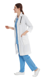 Doctor in clean uniform walking on white background