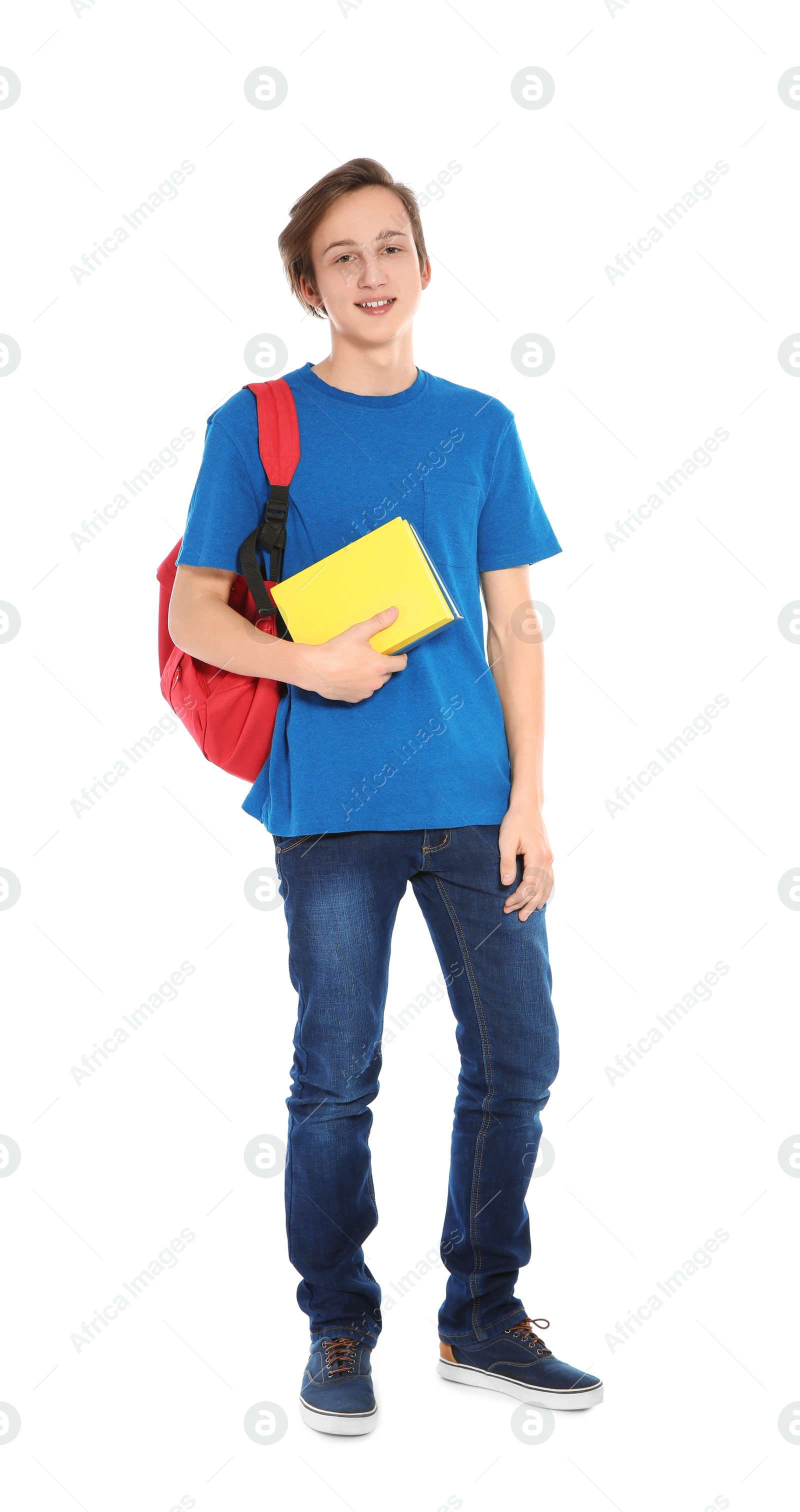 Photo of Handsome teenager boy with books on white background