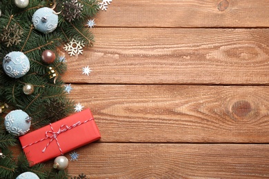 Photo of Flat lay composition with Christmas decorations on wooden background, space for text. Winter season