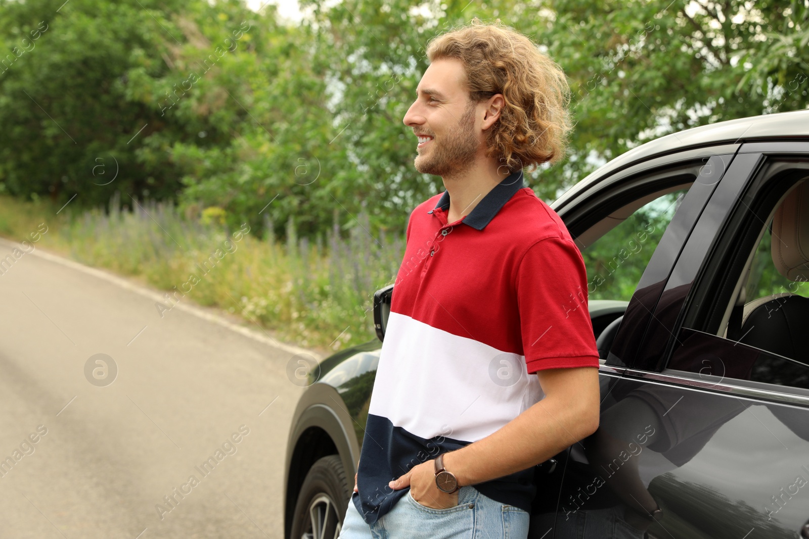 Photo of Attractive young man near luxury car outdoors