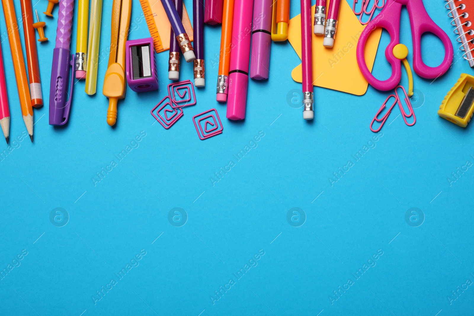 Photo of Flat lay composition with different stationery on light blue background, space for text