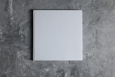 Photo of Blank paper sheets on grey textured background, top view. Mockup for design