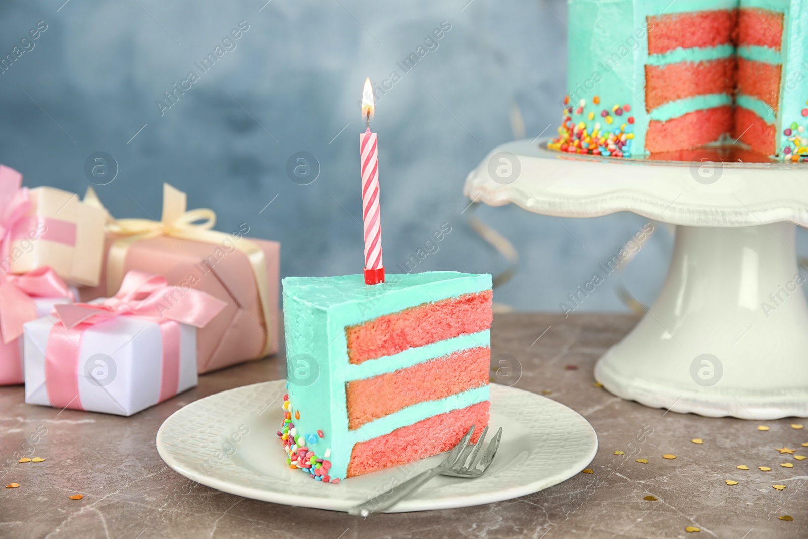 Photo of Slice of fresh delicious birthday cake with candle on table