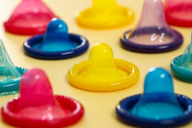 Photo of Condoms on beige background, closeup. Safe sex