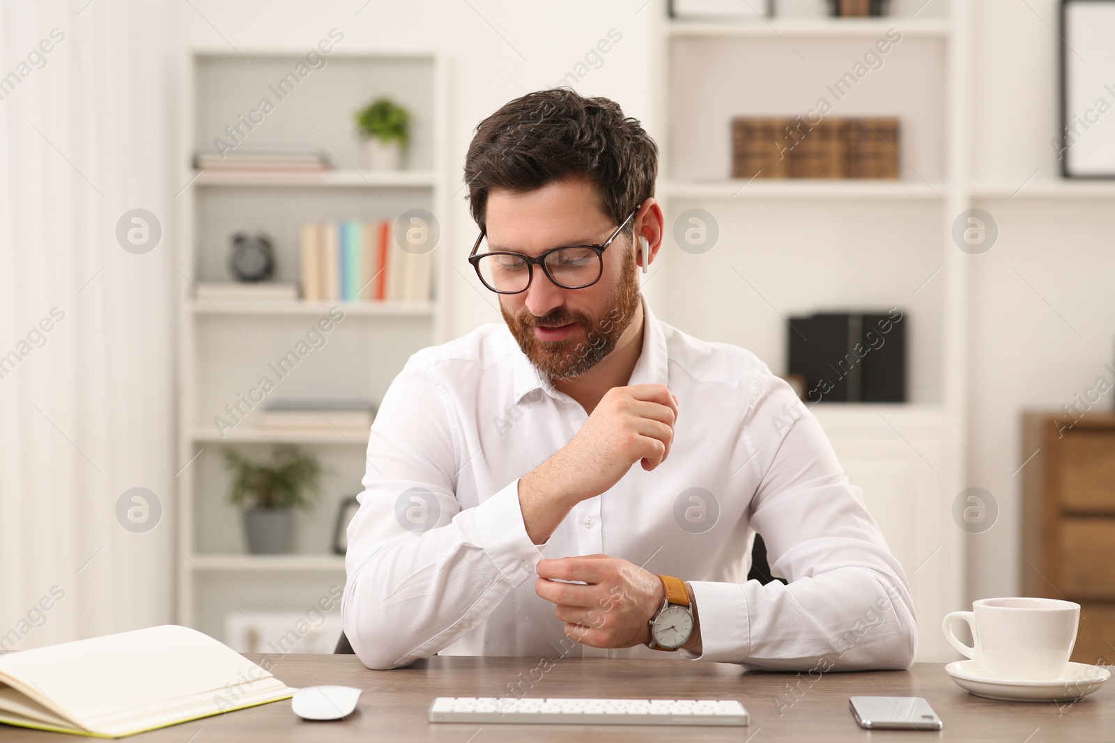 Photo of Businessman having online video call at wooden desk indoors, view from web camera