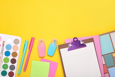 Photo of Flat lay composition with different school stationery on yellow background, space for text. Back to school