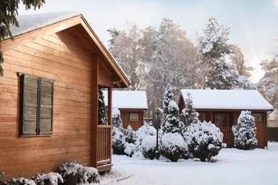 Winter landscape with beautiful houses, trees and bushes in morning