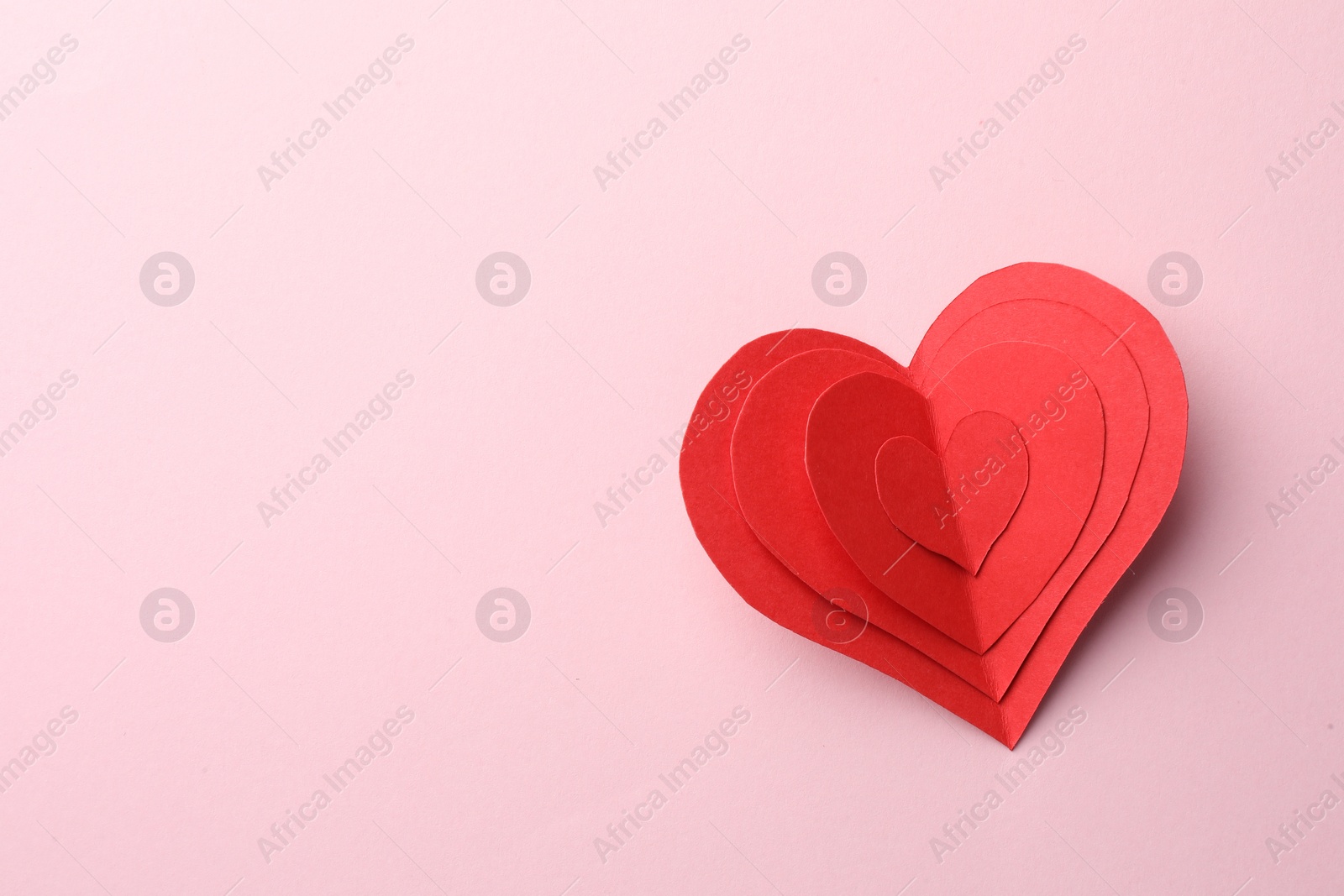 Photo of Paper hearts on pink background, top view. Space for text