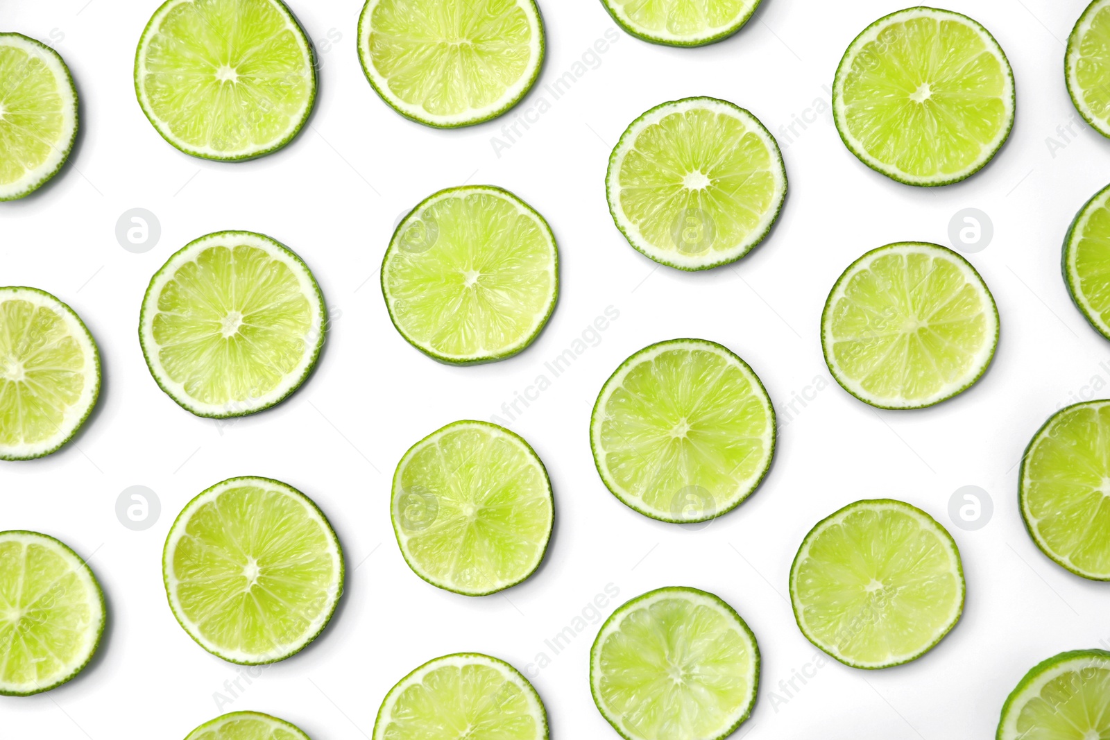 Photo of Slices of fresh juicy limes on white background, flat lay