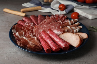 Photo of Plate with different sliced meat products served on table