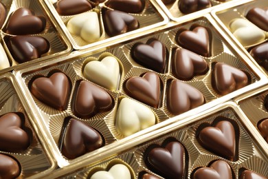 Beautiful heart shaped chocolate candies in box as background