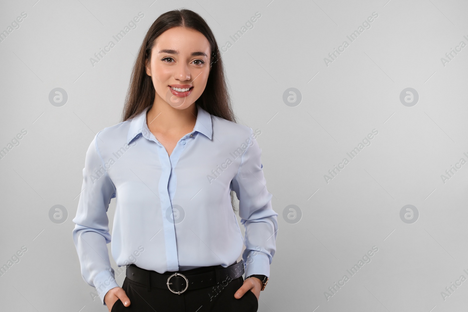 Photo of Portrait of beautiful young woman on light grey background. Space for text