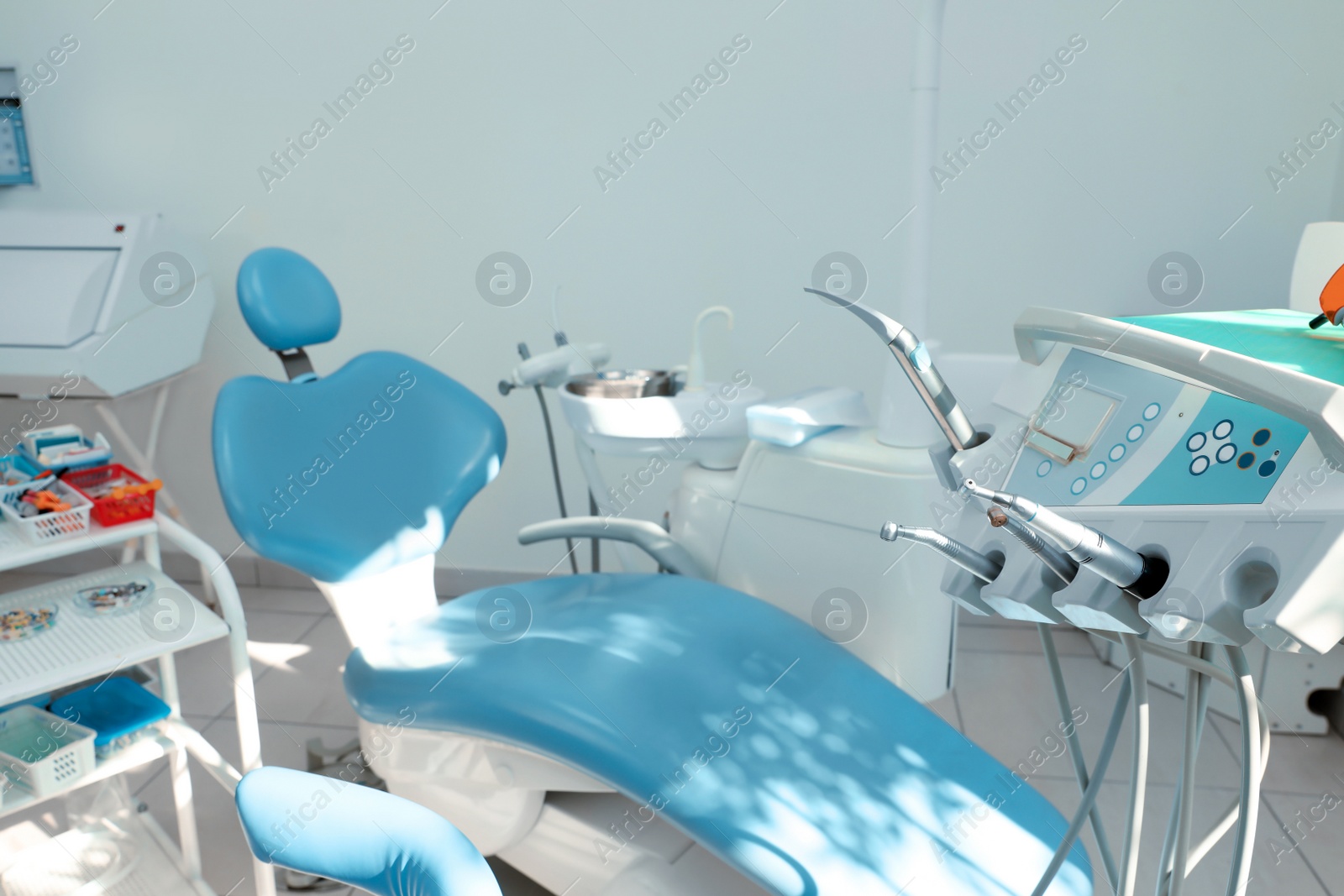 Photo of Dentist's office interior with chair and modern equipment