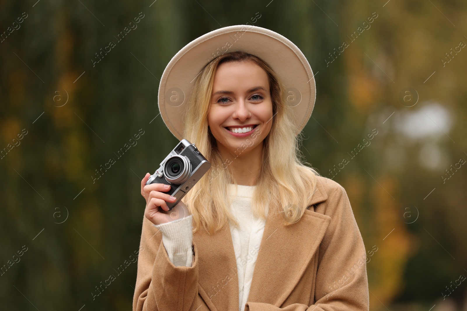 Photo of Autumn vibes. Portrait of happy woman with camera outdoors