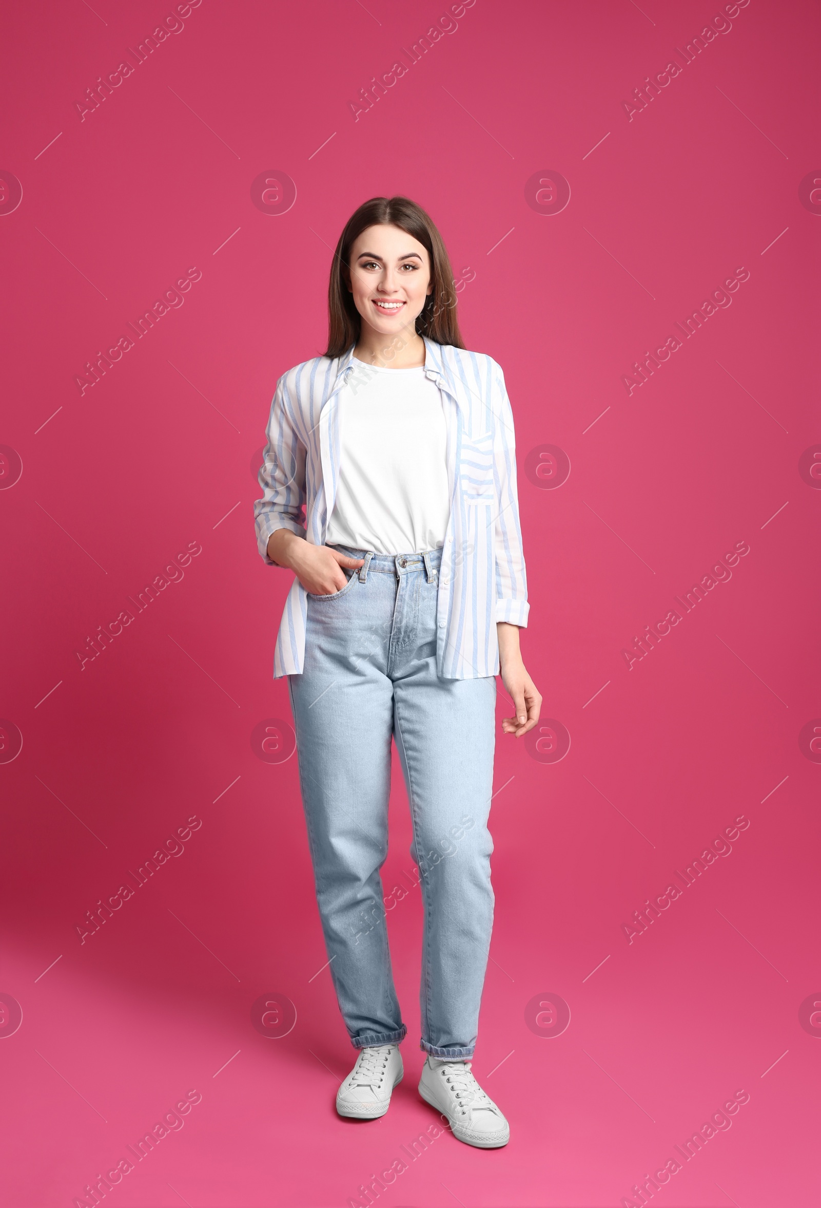 Photo of Full length portrait of young woman on pink background