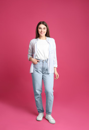 Photo of Full length portrait of young woman on pink background