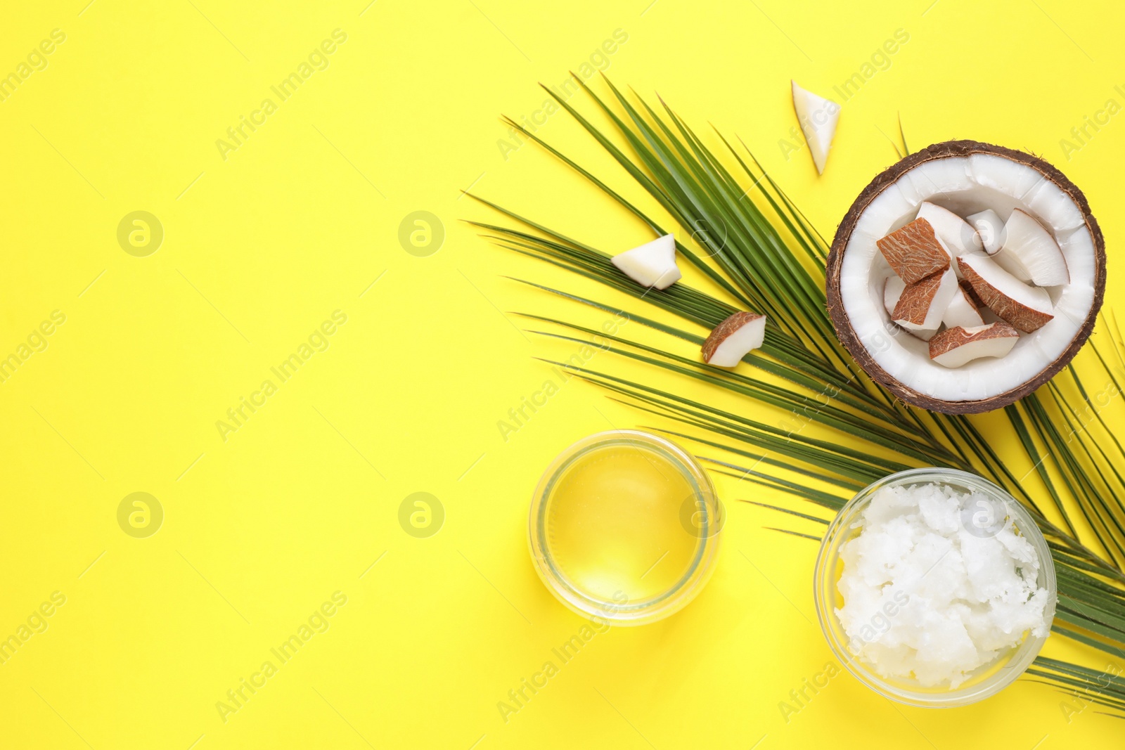 Photo of Flat lay composition with coconut oil on yellow background, space for text