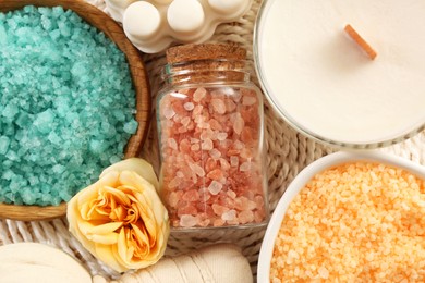 Photo of Flat lay composition with different types of aromatic sea salt on wicker mat