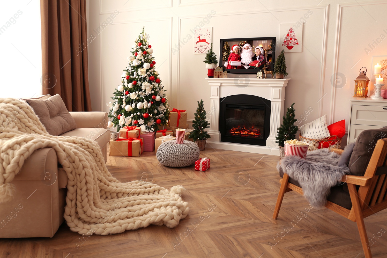 Image of Stylish living room interior with TV set, Christmas tree and fireplace