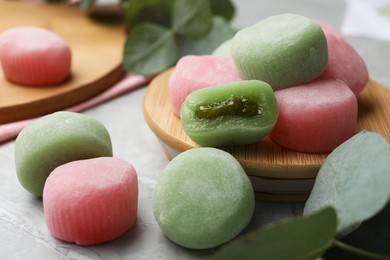 Many different delicious mochi on grey table. Traditional Japanese dessert
