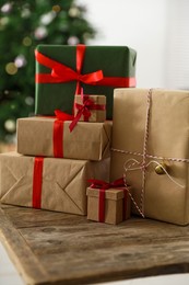 Beautifully wrapped Christmas gifts on wooden table indoors