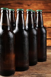 Many bottles of beer on wooden table