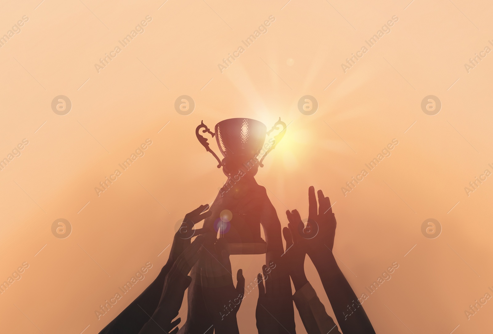 Image of People with gold trophy cup on color background, closeup