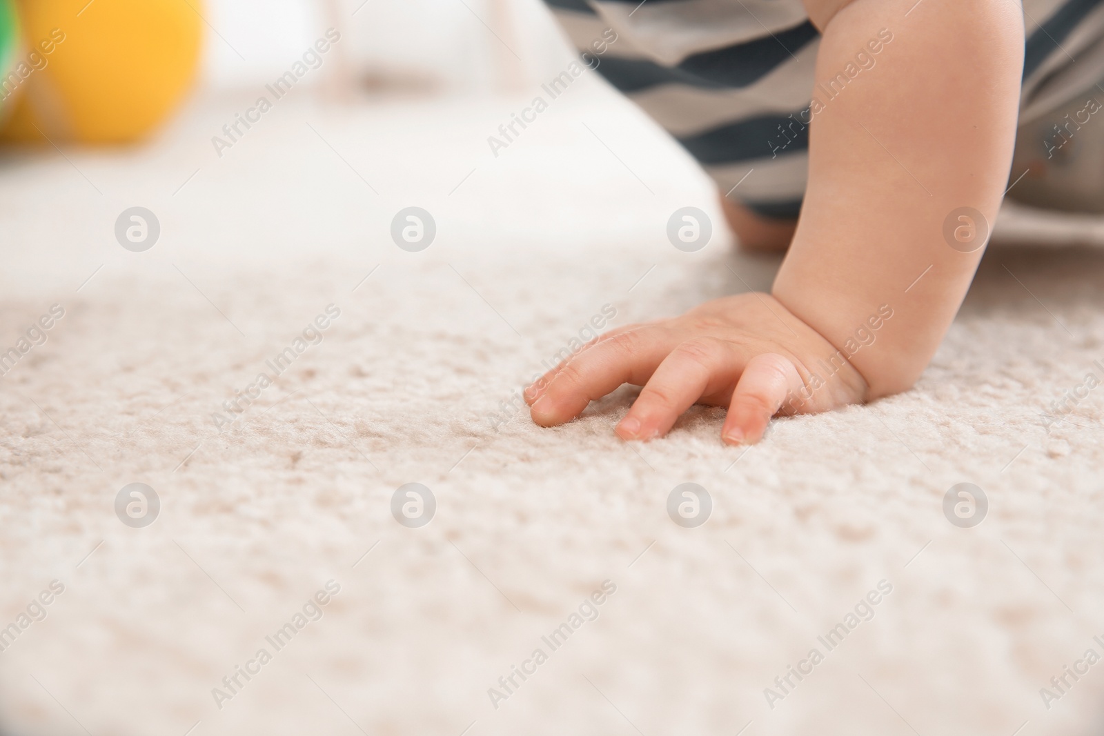 Photo of Cute little baby crawling on carpet indoors, closeup with space for text