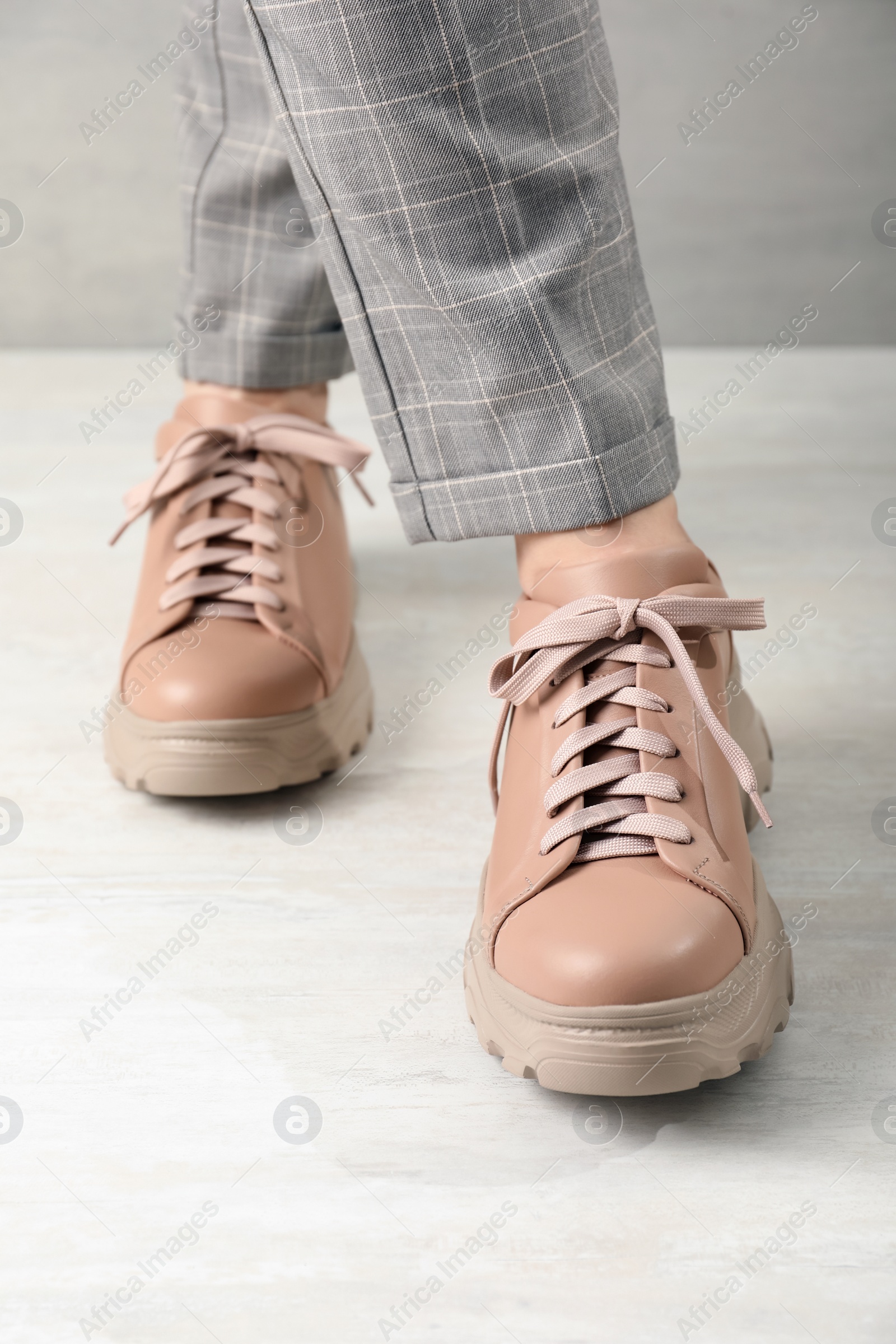 Photo of Woman wearing stylish leather shoes indoors, closeup