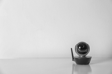 Modern CCTV security camera on white background. Space for text