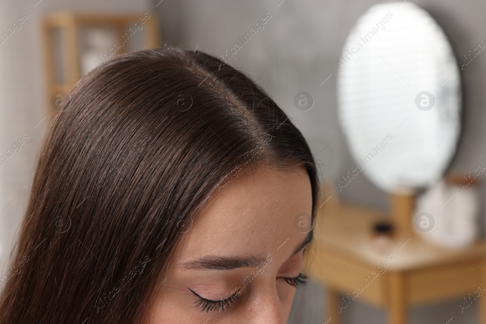 Photo of Woman with healthy hair indoors, closeup. Space for text