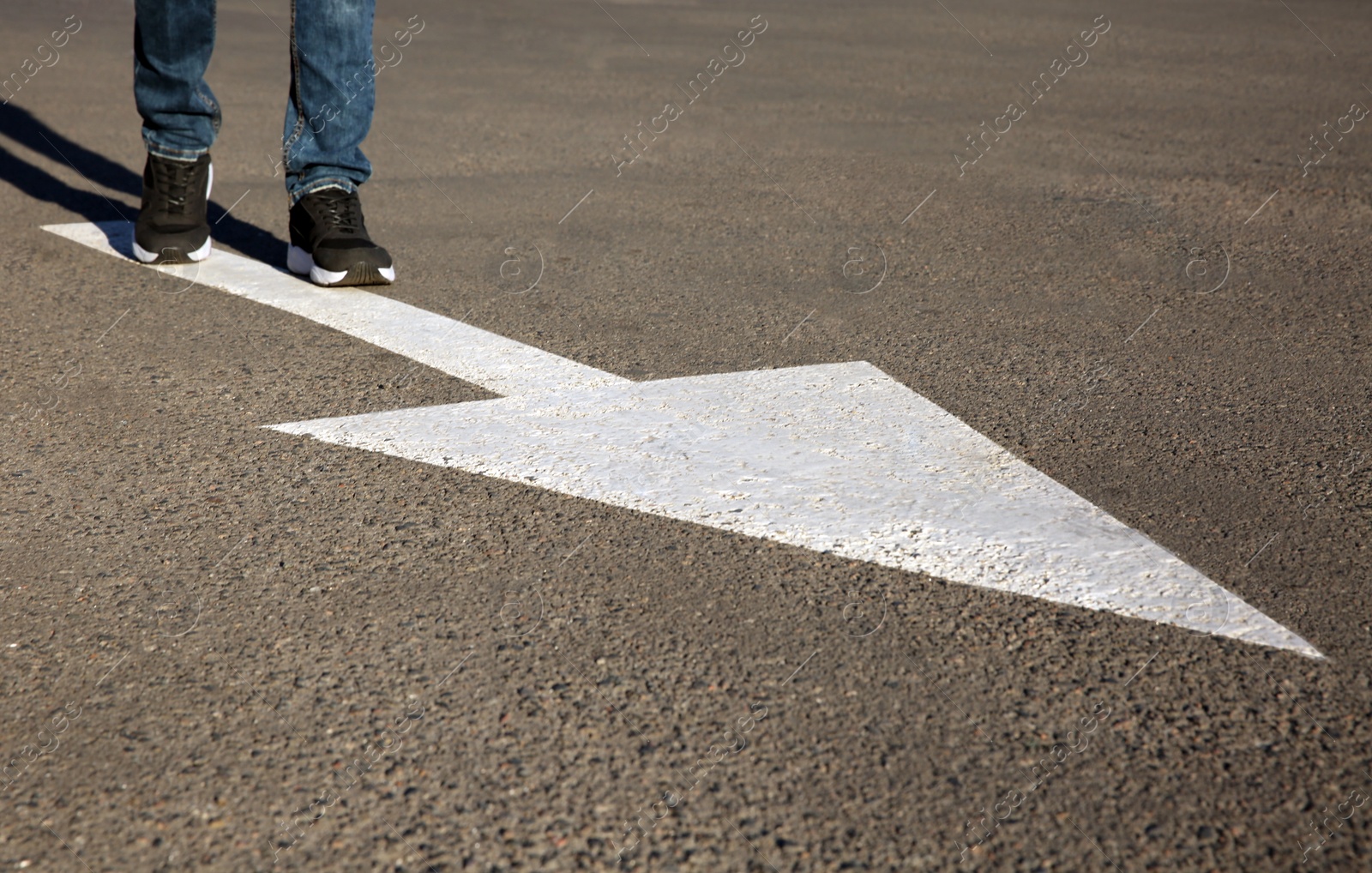 Photo of Man going along road with arrow marking, closeup