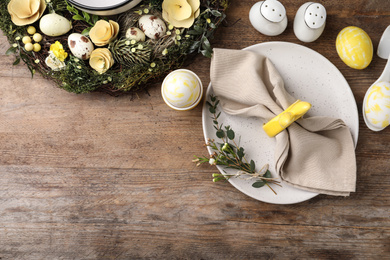 Photo of Rustic Easter table setting with eggs and floral decor, flat lay. Space for text