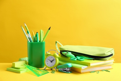 Photo of Different school stationery on yellow background