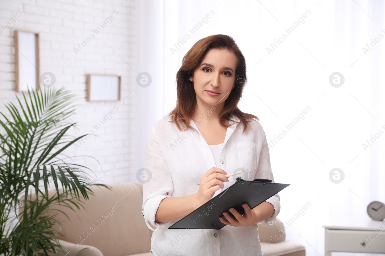Photo of Portrait of psychotherapist with clipboard at office