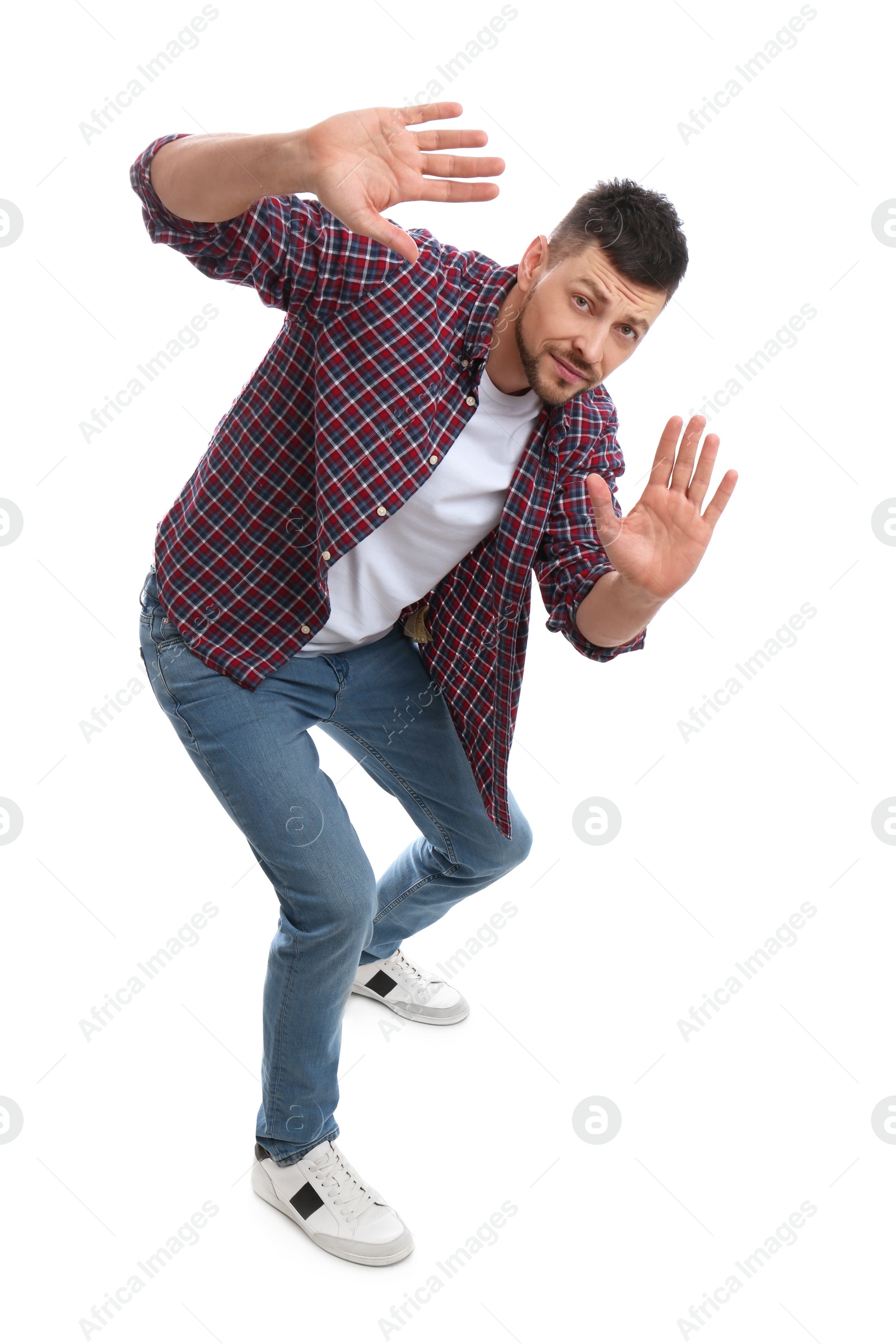 Photo of Emotional man evading something on white background