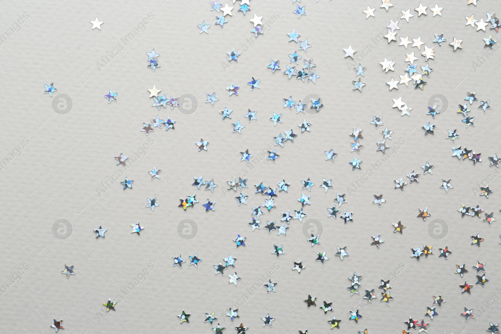 Photo of Confetti stars on grey background, flat lay Christmas celebration