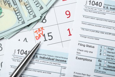 Photo of Tax day. Documents, dollar banknotes and pen on calendar with date reminder, flat lay