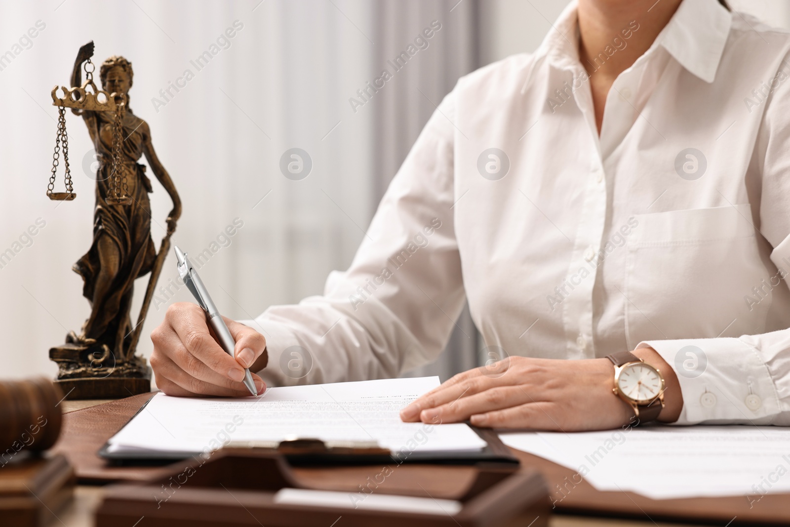 Photo of Lawyer working with documents at table in office, closeup