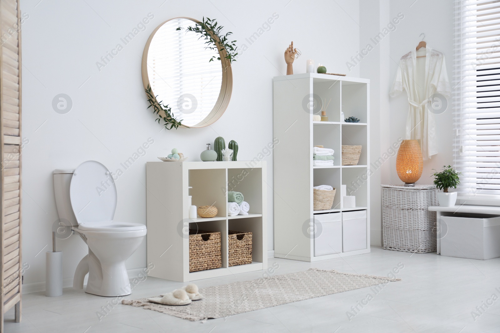 Photo of Interior of modern bathroom with round mirror