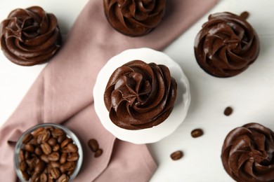 Photo of Flat lay composition with delicious chocolate cupcakes on white table