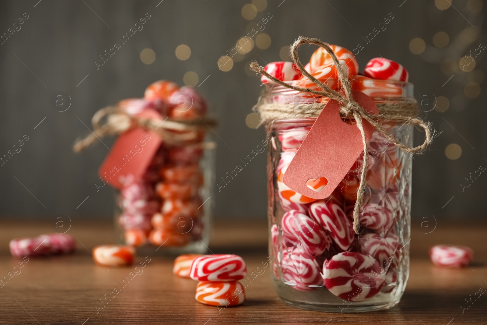 Photo of Color hard candies on wooden table. Space for text