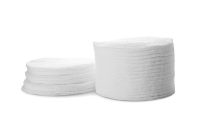 Photo of Stacks of cotton pads on white background