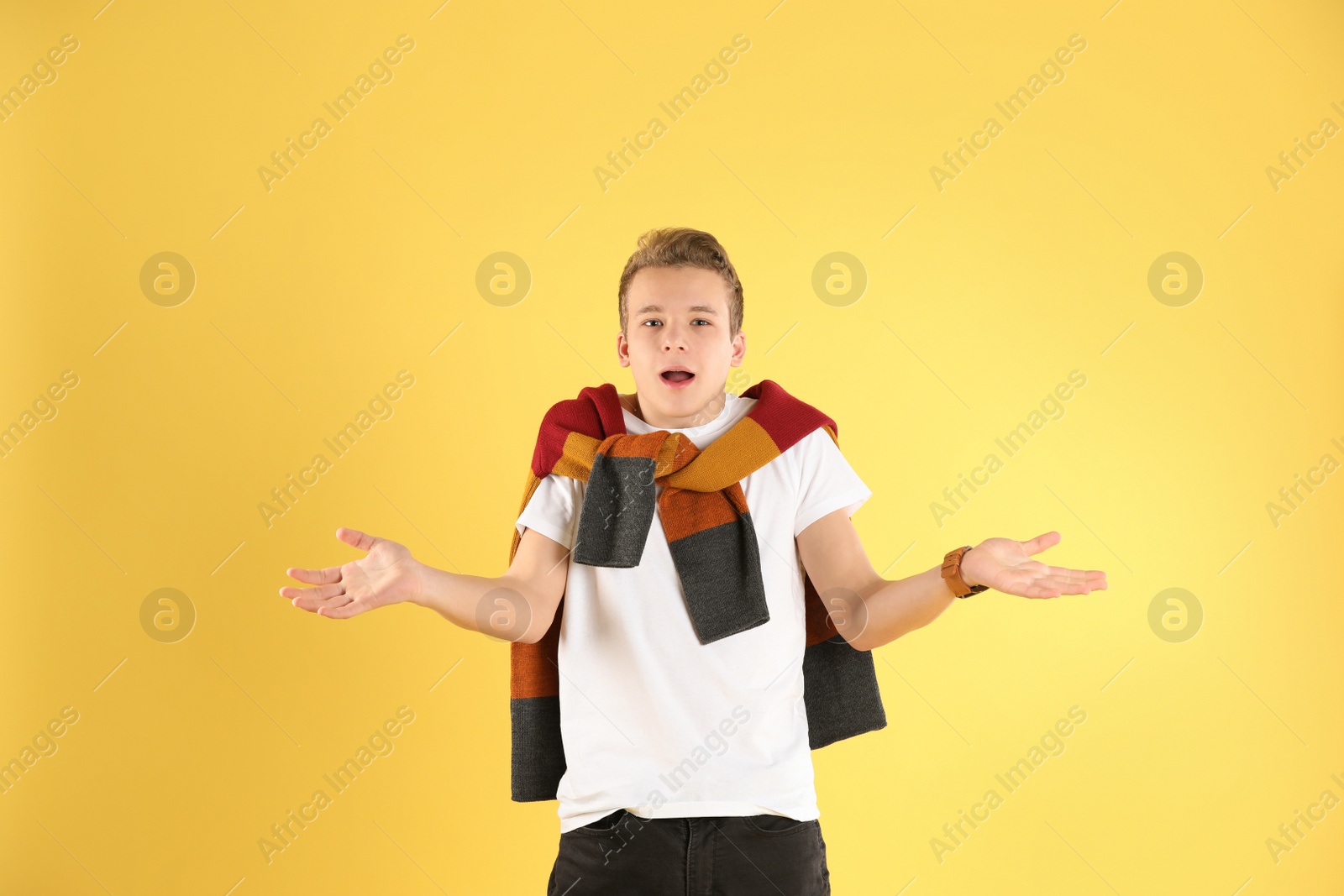 Photo of Portrait of emotional teenage boy on color background