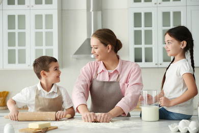 Happy family cooking together in kitchen at home