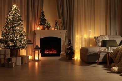 Photo of Stylish living room interior with beautiful fireplace, Christmas tree