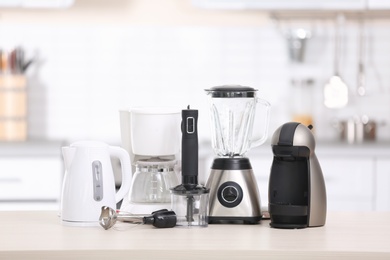 Photo of Different modern kitchen appliances on table indoors. Interior element