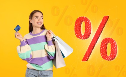 Image of Discount offer. Beautiful woman with credit card and shopping bags on golden background. Percent signs near her